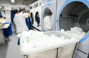 A friendly and professional team at Tuckahoe Laundry standing together